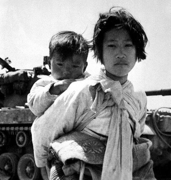 Image: Photo of a Girl and her brother during the Korean War by Maj. R.V. Spencer, 1951. From the Flickr Commons.