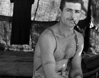 Image: Photo of unemployed lumber worker with social security number tattooed on his arm taken by Dorothea Lange in 1939. From the Library of Congress.