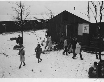Image: Photo of people leaving Buddhist church in Manzanar Relocation Center taken by Ansel Adams in 1943. From the Library of Congress.